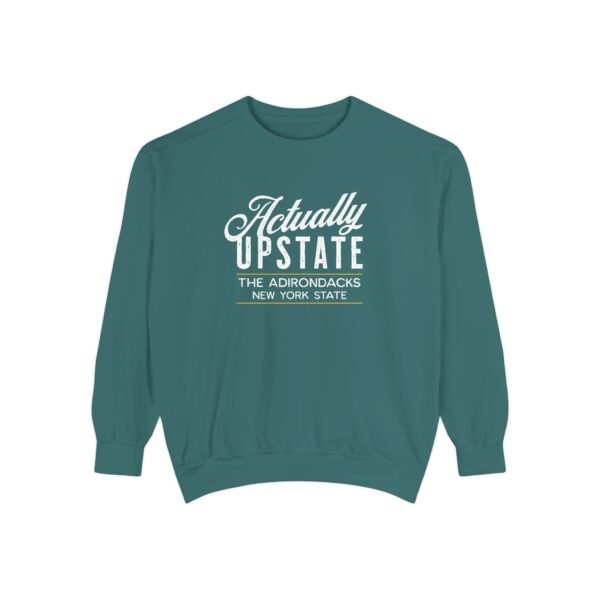 A photo of a crewneck sweater in blue spruce with text reading "Actually Upstate: The Adirondacks, New York State"